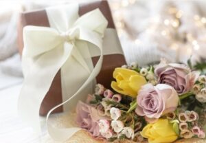 Floral details on wedding elements boutonnieres and sunflower corsages with cake toppers and aisle markers.